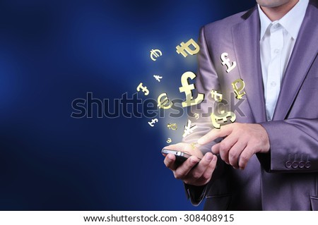 Currency gold symbols fly from a mobile phone