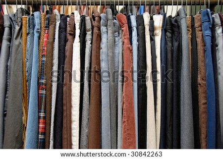 A rack of mens pants in a second hand shop Royalty-Free Stock Photo #30842263