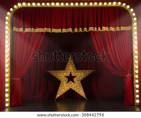 Theater stage with red curtains and spotlights. Theatrical scene in the light of searchlights  Royalty-Free Stock Photo #308442794