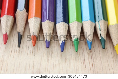 colored pencils on wood background