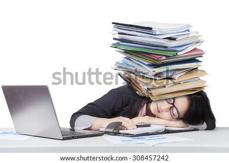Portrait of overworked female worker sleeping on desk with paperwork over head, isolated on white