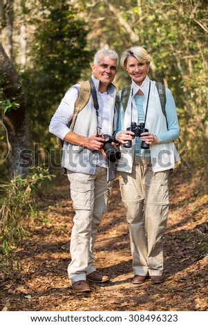 beautiful old couple standing in the forest