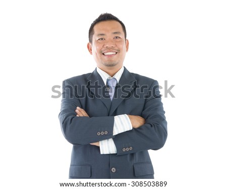 Confident Southeast Asian businessman crossed arms over white background Royalty-Free Stock Photo #308503889