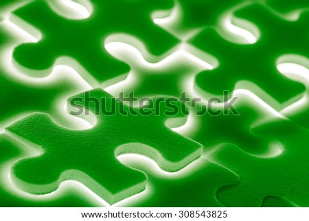 Background of large shining puzzles in green