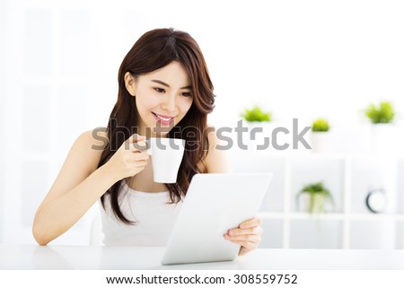 Young smiling  woman  with tablet pc