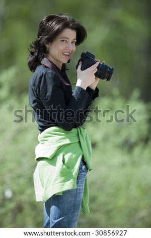  pretty female photographer in a forest.