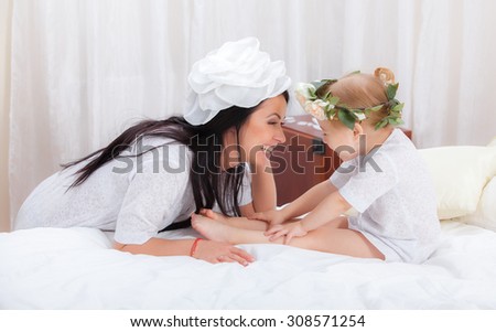 Happy Mother and daughter in bed