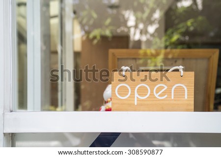 "Open" word on the wooden board in front of the shop