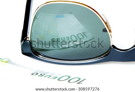 one hundred euro reflected in sunglasses of greedy man eyes