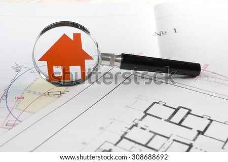 Magnifying glass, model house, construction plan for house building.  Real Estate Concept. 