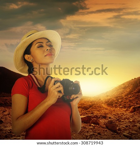 A tourist taking image with camera on mountain landscape