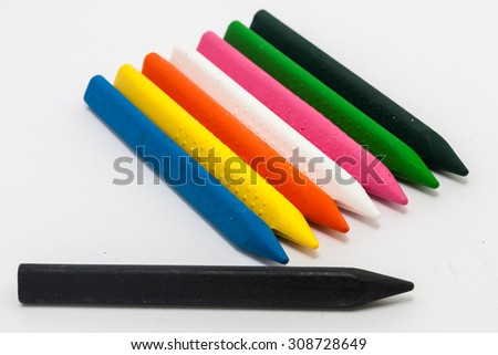 Different colors of crayons on white background