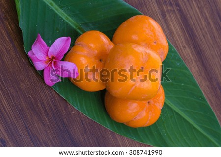 persimmon on a banana leaf.