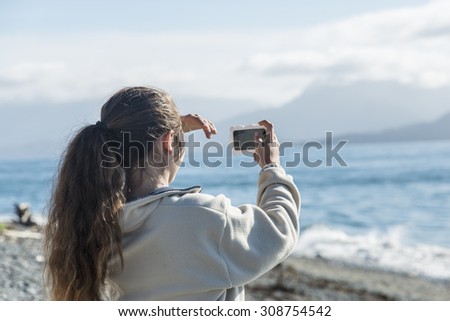 Taking a selfie with her phone in Homer, Alaska