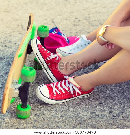 Hipster teenage friends with skateboard, colorised image 