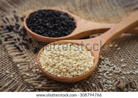 White sesame and black sesame seed on wooden spoon Royalty-Free Stock Photo #308794766