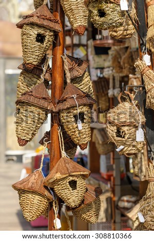 A selection of woven bird boxes for sale.