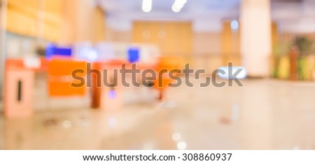 blur image of computer laptop in business centre for background usage.