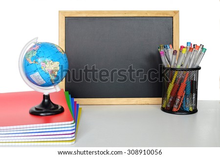Back to school: Blackboard and school supplies on the table
