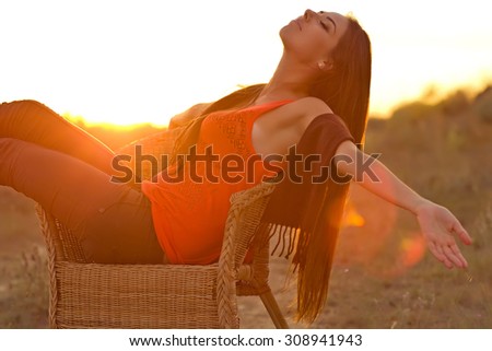 Portrait of a happy woman, warm autumn sunset