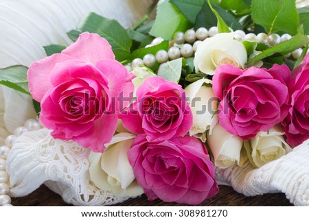 fresh pink  and white roses with lace and pearls