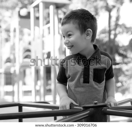 Boy riding a carousel at the playground
