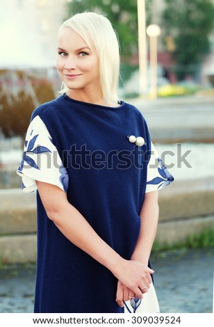 young blond woman walking on the street