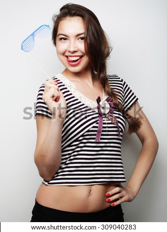 Party image. Playful young women holding a party glasses. Ready for good time.