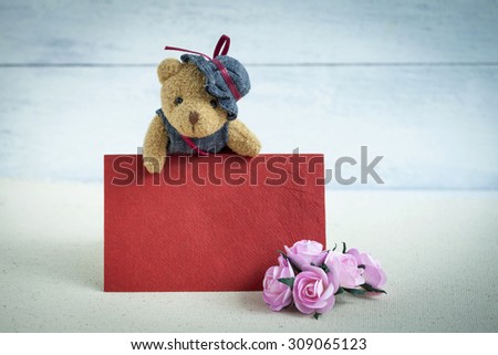 Teddy bear with blank red card