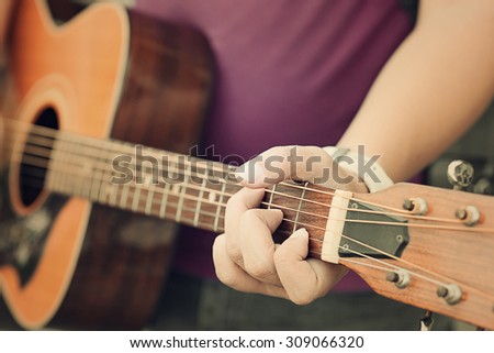 Man playing guitar , close up,guitarist plays,Music Team
