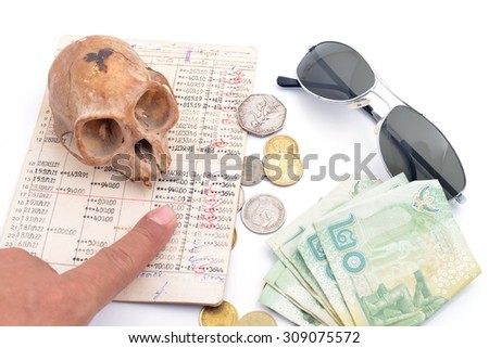 skull , coins and account book. Concept 