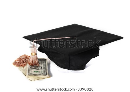 Graduation mortarboard hat with money on white...high cost of education, or earnings potential with a degree