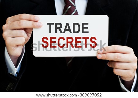 Trade Secrets Concept. Man holding a card with a message text written on it