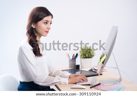 Graphic designer working on computer with color palette, wacom tablet on the table. Isolated on white background