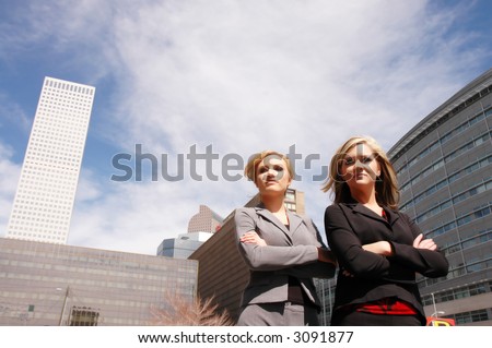 business woman posing in front of a skyscraper in downtown denver