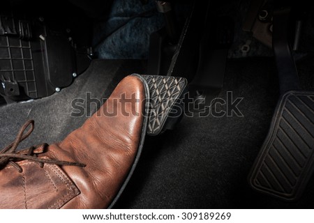 foot pressing the brake pedal of a car Royalty-Free Stock Photo #309189269