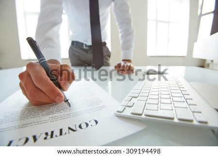 Businessman reading contract with attention