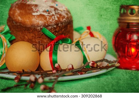 Easter background with decorated with still life with eggs, red festive cupcake and candle holder with candles