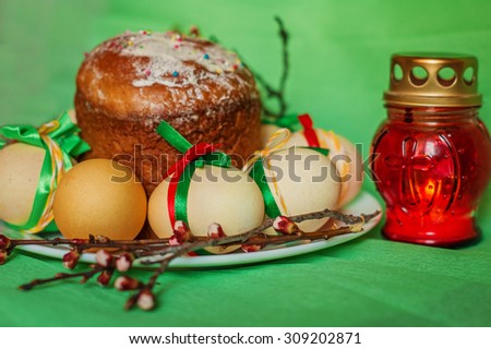Easter background with decorated with still life with eggs, red festive cupcake and candle holder with candles