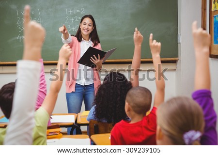 Teacher asking her students a question at the elementary school Royalty-Free Stock Photo #309239105