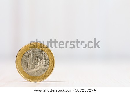 One euro coin on white wood  background. With copy-space for text