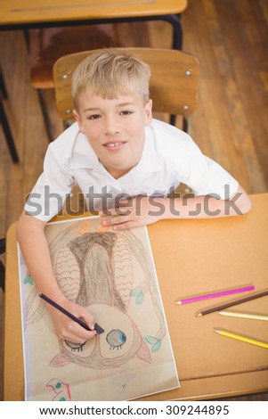 Student drawing on a sheet of paper at the elementary school