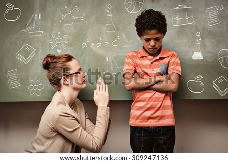 School doodles against teacher apologizing boy in classroom Royalty-Free Stock Photo #309247136