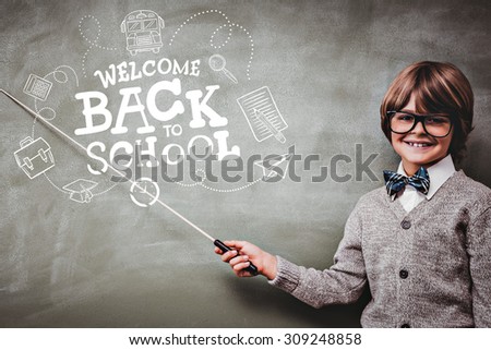 back to school against boy holding stick in front of blackboard