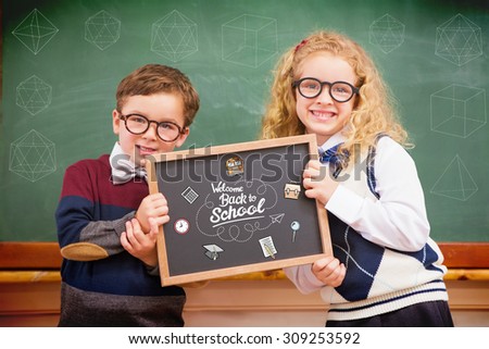 geometric shape against pupils holding blackboard