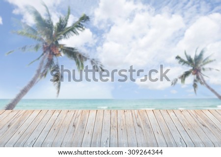 Wood table top on blue sea & palm background