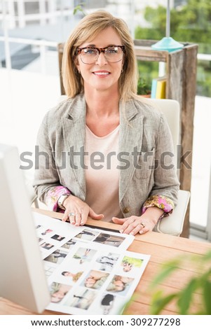 Portrait of smiling casual designer working at her desk in the office