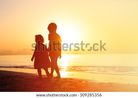 Little Boy And Girl Holding Hands Walking On Sunset Beach Stock Photos And Images Avopix Com