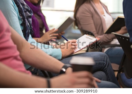 Close up view of student taking notes during lecture Royalty-Free Stock Photo #309289910