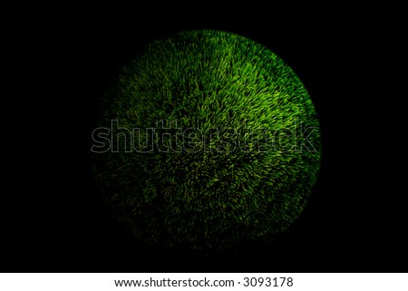 Green fluffy ball on black background